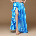 Woman wearing a shiny blue ruffled high-slit skirt on a tan background