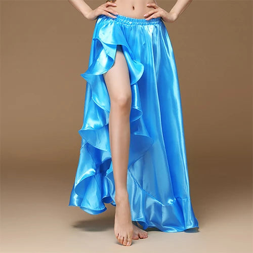 Woman wearing a shiny blue ruffled high-slit skirt on a tan background