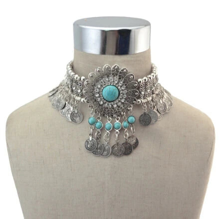 Boho choker necklace with turquoise stones and silver coin pendants on display bust.