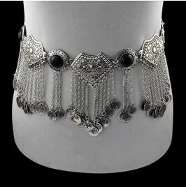 Ornate silver belly dance belt with coins and chain fringe on mannequin waist