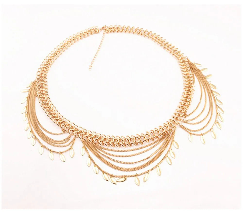 Gold statement necklace with layered chains and leaf-shaped pendants on white background
