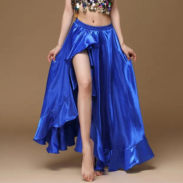 Woman wearing shiny royal blue high-slit ruffled dance skirt on beige background