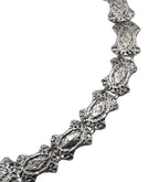 Textured silver chain necklace with ornate, vintage-style links on a white background.