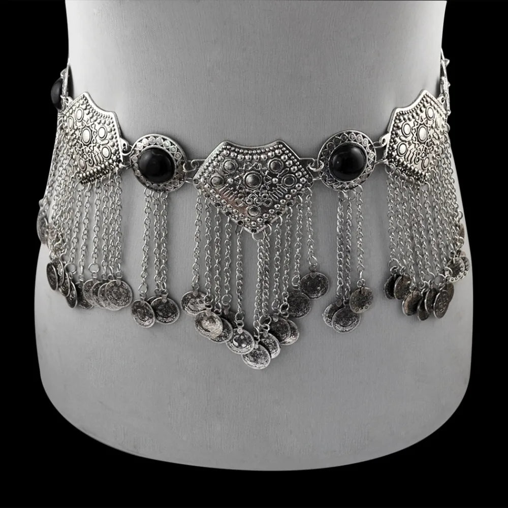 Silver boho coin belt with ornate details and hanging chains, displayed on a mannequin.