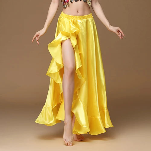 Yellow satin ruffle skirt with high slit, model standing barefoot against beige background