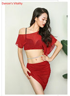 Woman in red two-piece dance outfit with off-shoulder crop top and asymmetrical skirt