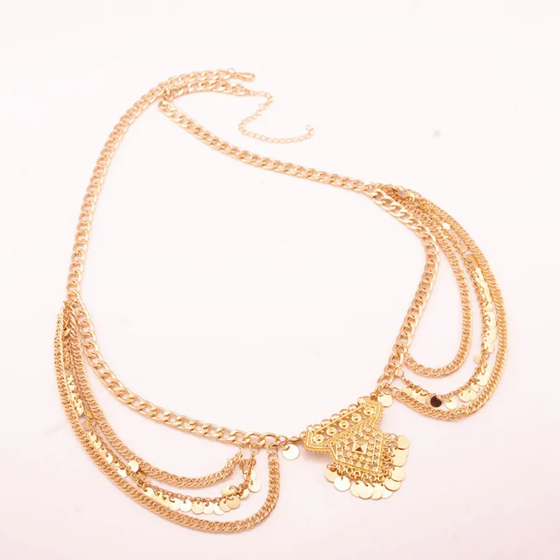 Layered gold statement necklace with geometric pendant and decorative chains