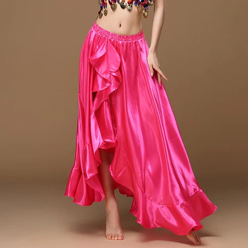 Woman wearing a vibrant pink satin ruffled skirt, bare feet, brown background