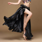 Woman wearing a flowing black satin belly dance skirt and colorful coin hip scarf