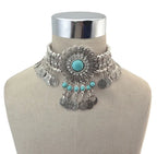 Boho silver choker necklace with turquoise stones and coin pendants on mannequin bust