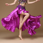 Woman dancing in a vibrant purple satin belly dance skirt with sequin top