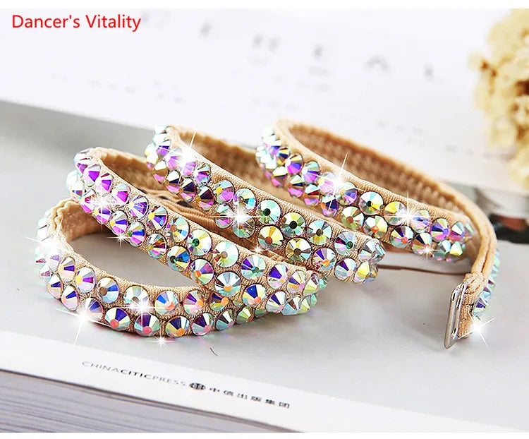Sparkling rhinestone embellished bracelets with tan band on a light surface, jewelry accessory