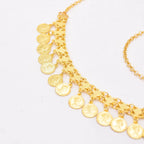Gold coin charm necklace with intricate chain detail on a white background