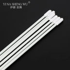 Set of white cotton swabs with long handles on a black background