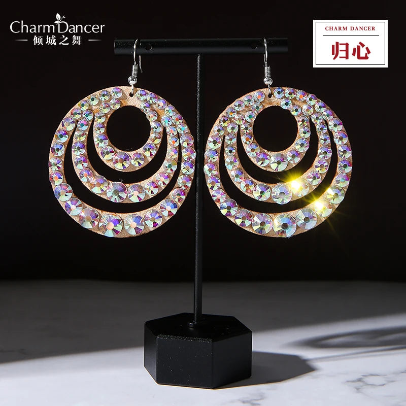 Glittering circular rhinestone dangle earrings with layered hoops on display stand
