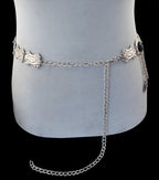 Silver chain belt with decorative engraved plates displayed on a torso mannequin