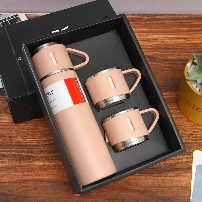 Beige insulated thermos and two mugs gift set in a black box on wooden table