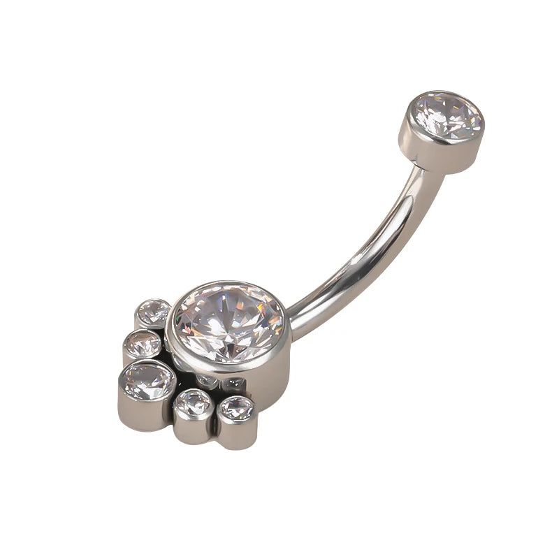 Silver curved belly ring with multiple clear gemstones on white background