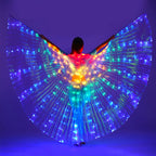 Person wearing large LED light up wings costume in rainbow colors on a purple background