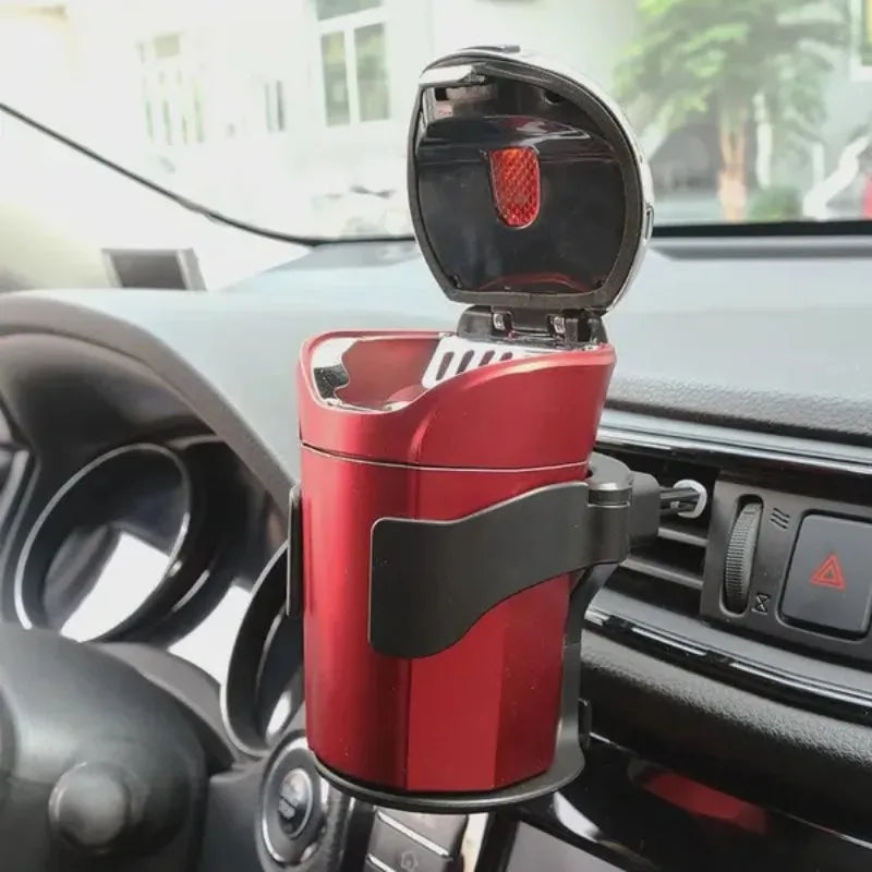 Red car ashtray with lid, clipped to air vent inside vehicle interior.