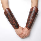 Pair of brown faux leather bracers with embossed Viking runes and intricate designs on arms
