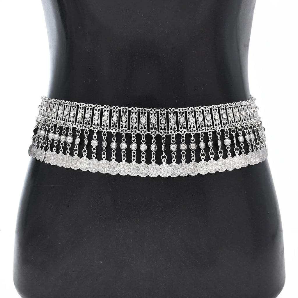 Silver boho coin chain waist belt with ornate details on mannequin torso