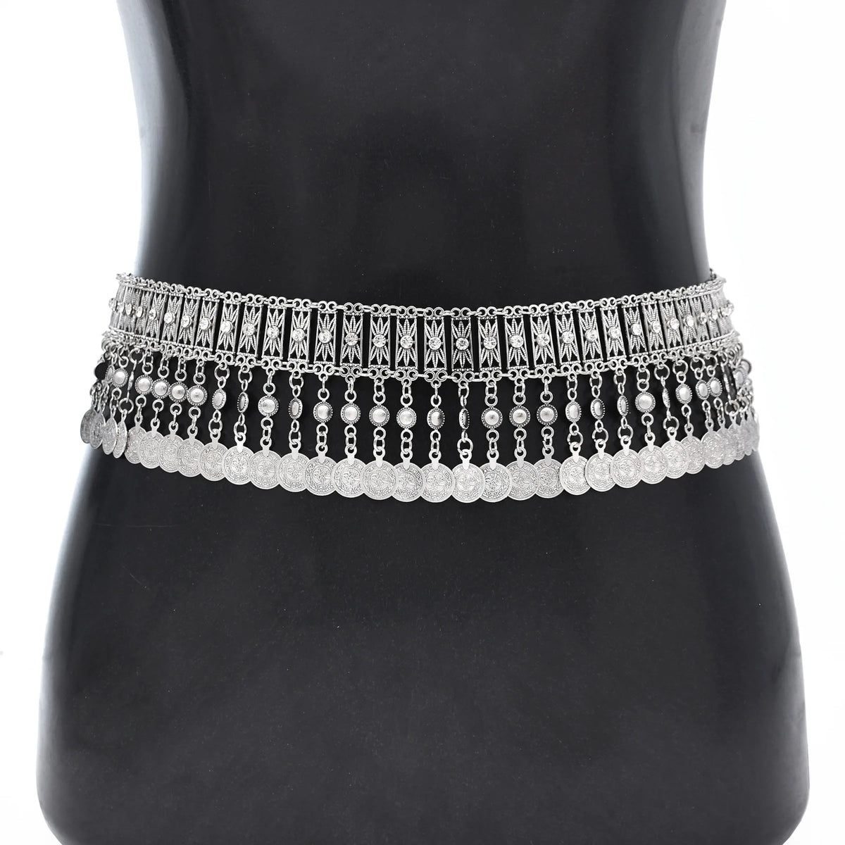 Silver boho coin chain waist belt with ornate details on mannequin torso