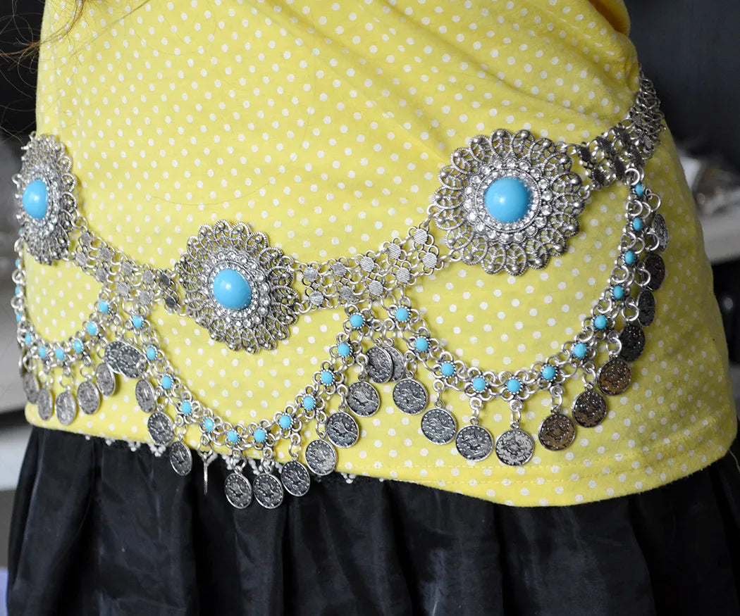 Silver coin belly dance hip belt with turquoise stones on yellow polka dot dress