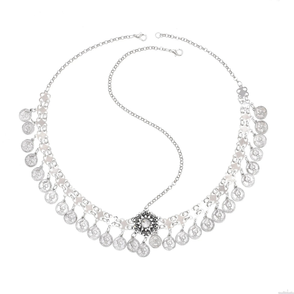 Silver coin charm necklace with decorative floral center, laid flat on white background