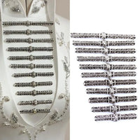 Set of ornate silver frog buttons displayed on white fabric and separately on a white background