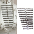 Set of ornate silver frog buttons displayed on white fabric and separately on a white background