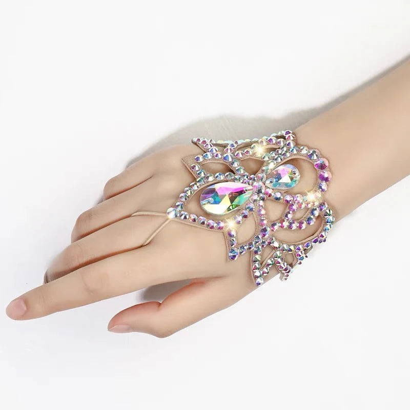 Hand wearing a large, iridescent rhinestone statement bracelet on white background