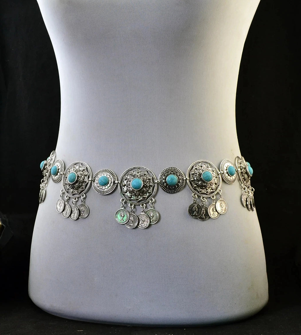 Bohemian silver waist chain with turquoise accents and dangling coin charms on mannequin