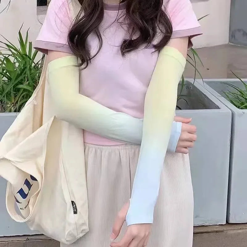 Woman wearing pastel ombre arm sleeves, light pink top, beige skirt, and canvas tote bag