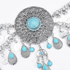Boho statement necklace with intricate silver filigree and turquoise accents