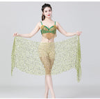 Woman modeling a green and gold belly dance costume with beaded shawl and fringe details