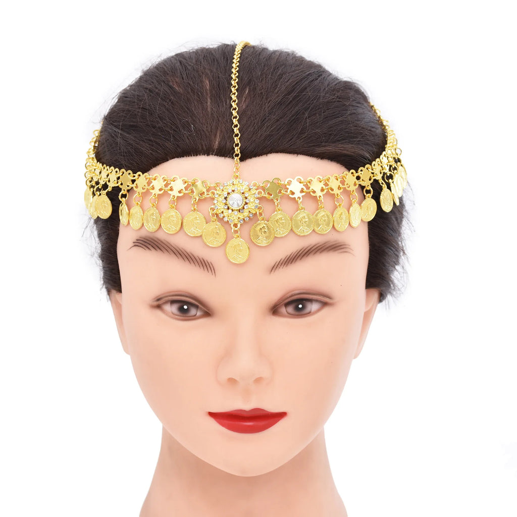 Mannequin wearing gold coin headpiece with chain and central jeweled accent