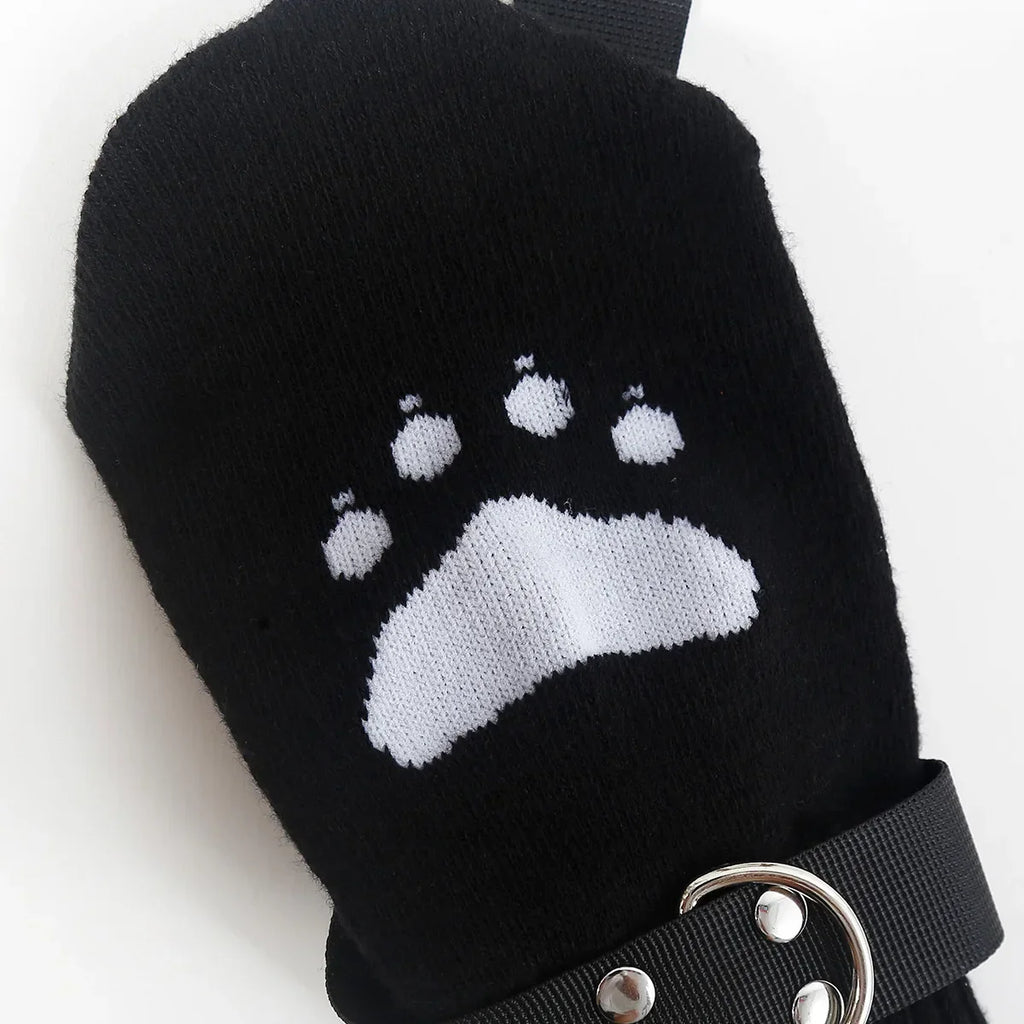 Black mitten with white animal paw print and adjustable strap for outdoor or pet care use