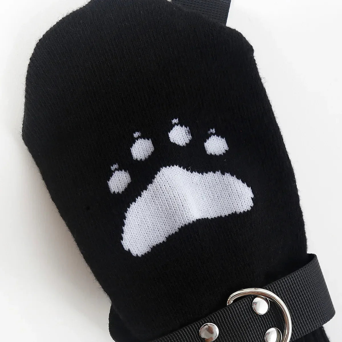 Black mitten with white animal paw print and adjustable strap for outdoor or pet care use