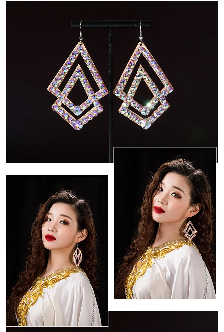 Woman wearing geometric crystal dangle earrings, iridescent statement jewelry on black background