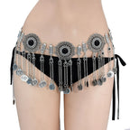 Ornate belly dance hip scarf with silver coins and black accents over black bikini bottoms