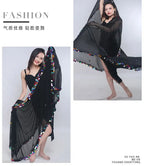 Woman modeling sheer black dance shawl with colorful sequin trim, fashion photography