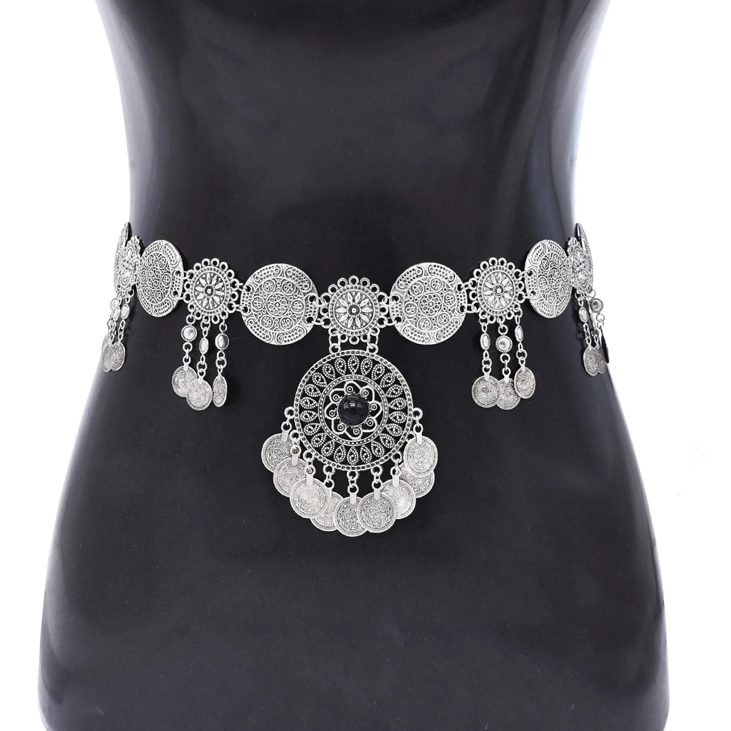 Silver coin waist belt with intricate round designs and dangling charms on a mannequin