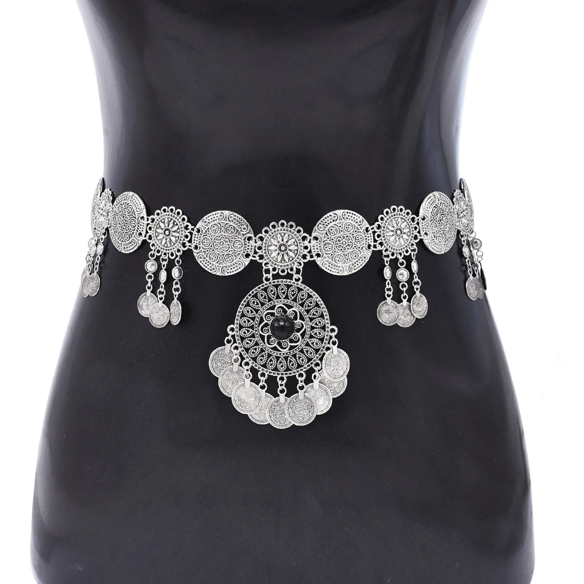 Silver coin waist belt with intricate round designs and dangling charms on a mannequin