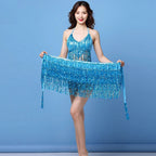 Woman in blue sequin fringe dance costume posing against a blue background