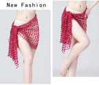 Woman wearing pink sequin hip scarf, belly dance accessory tied at waist, white background