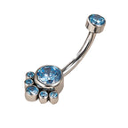 Silver curved belly button ring with blue gemstones in a paw print design