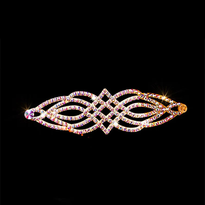 Gold-tone rhinestone hair barrette with geometric design, sparkling on black background