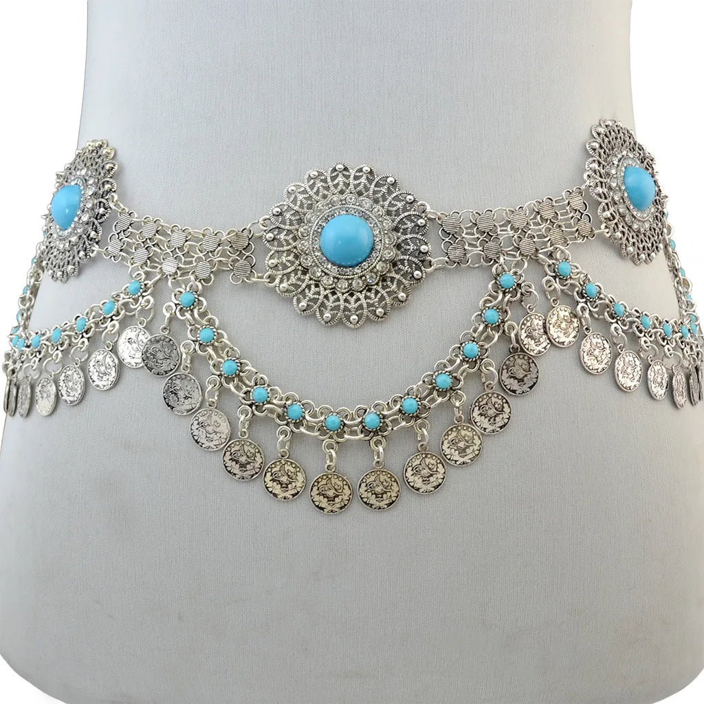 Silver waist chain belt with turquoise stones and dangling coin charms, displayed on mannequin.