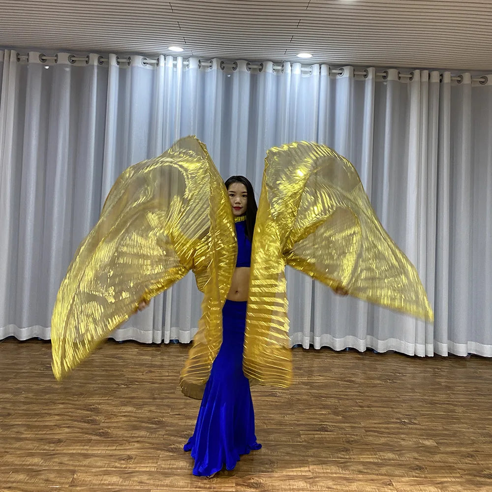 Dancer in blue costume performing with large gold metallic wings indoors